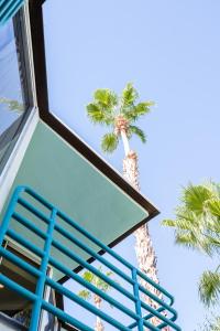 a blue staircase with palm trees in the background at Margaritaville Resort Palm Springs in Palm Springs
