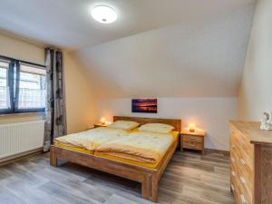 a bedroom with a bed and two night stands at Apartment in Westerwald with private balcony 