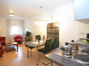 a kitchen and living room with a table and chairs at Wohnung nahe dem Skigebiet in Wehrstapel in Meschede