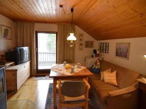 a living room with a couch and a table at Holiday home in Saldenburg with sauna in Saldenburg