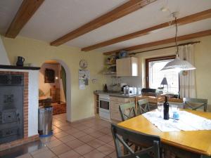 a kitchen and dining room with a table and chairs at Holiday home in Saldenburg with sauna in Saldenburg