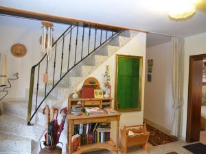 uma escada com uma estante de livros e uma porta verde em Holiday home in Saldenburg with sauna em Saldenburg