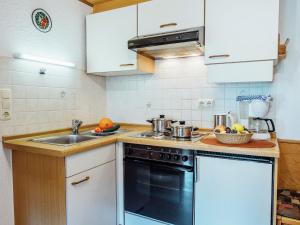 a kitchen with a sink and a stove top oven at Apartment near the forest in Plankenstein in Plankenfels