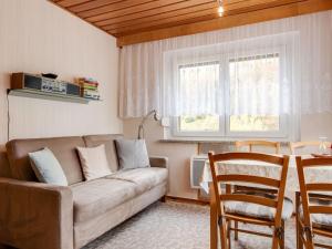 a living room with a couch and a table at Attractive holiday home in Sch nbrunn with garden in Schönbrunn