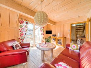 a living room with a couch and a table at Apartment with barbecue in M hrenbach in Möhrenbach