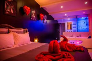 a bedroom with a bed with an animal blanket on it at SECRET SUITE "Mr Grey" - Jacuzzi privatif - Gare RER C - Proche Paris in Brétigny-sur-Orge