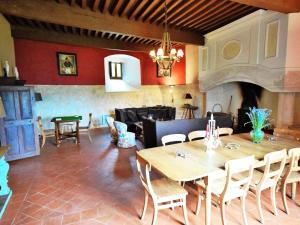 a living room with a table and a couch at Castle near Agen with Shared Pool in Saint-Caprais-de-Lerm