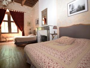 a bedroom with two beds and two windows at Castle near Agen with Shared Pool in Saint-Caprais-de-Lerm