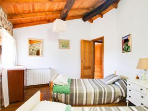 a bedroom with a bed and a wooden ceiling at Holiday Home in Castrotañe near Sil Cañon in Castillón +32 photos