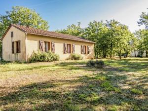 an old house in a field with trees at Holiday home with swimming pool in Salignac