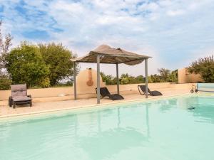 a swimming pool with a gazebo and chairs at Villa in Saint Nexans with Private Heated Pool in Saint-Nexans