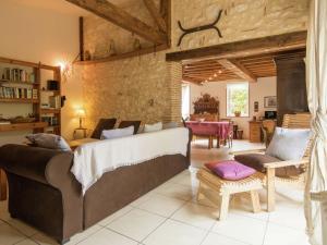 a living room with a couch and a table at Villa in Saint Nexans with Private Heated Pool in Saint-Nexans