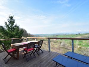 a wooden deck with a table and chairs on it at Modern apartment in Cuzy with shared pool in Cuzy