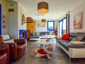 a living room with a couch and a table at Villa with indoor pool jacuzzi sauna in Moëlan-sur-Mer