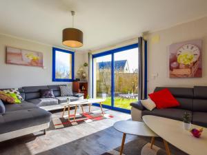 a living room with a couch and a table at Villa with indoor pool jacuzzi sauna in Moëlan-sur-Mer