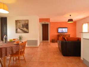 a living room with a table and a couch at Modern holiday home with a garden near the beach in Saint-Hilaire-la-Forêt