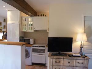 a kitchen with a desk with a computer monitor on it at Traditional house with garden in Dampsmesnil in Écos