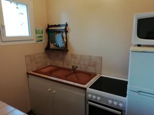 a kitchen with a sink and a microwave at Modern holiday home in Quend Plage les Pins in Quend