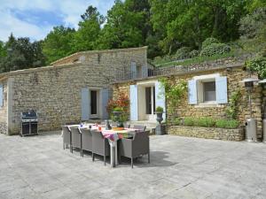 a patio with tables and chairs in front of a building at Cozy Villa in M nerbes with Swimming Pool in Ménerbes