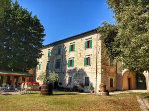 Gualdo CattaneoにあるBelvilla by OYO Splendid Farmhouse with Jacuzziの大きな石造りの建物で、カラフルな窓が付いています。
