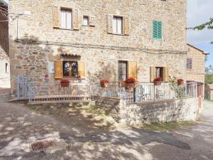 a stone house with a fence in front of it at Charmante Home with Garden in San Valentino