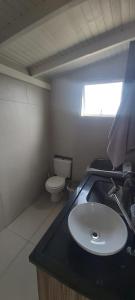 a bathroom with a sink and a toilet at Apartment Residencial Lídia Milani in Florianópolis