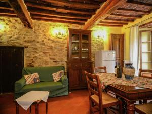a living room with a green couch and a table at Stunning Holiday Home in Umbria With Jacuzzi in Monte Santa Maria Tiberina