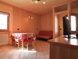 a living room with a table and a television at Belvilla by OYO Casa Marinella in Livigno
