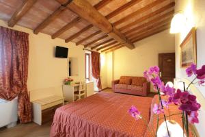 Postel nebo postele na pokoji v ubytování Hotel Villa San Michele
