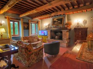 a living room with a couch and a fireplace at Belvilla by OYO Villa La Palazzeta in Ficulle