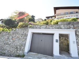 a stone retaining wall with a garage door at Belvilla by OYO Capriccio in Ghiffa