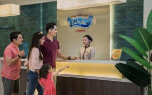 a group of people standing around a counter at Sunway Lost World Hotel in Ipoh