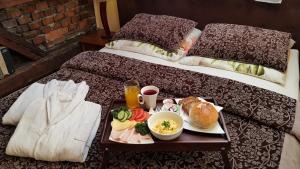 a table with a tray of food on a bed at Apartament Pool SPA z jacuzzi in Strzyżów