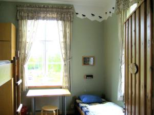 a bedroom with a bed and a window at Farmhouse with facilities in the middle of nature in Sysslebäck