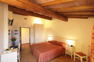 Postel nebo postele na pokoji v ubytování Hotel Villa San Michele