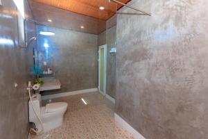 a bathroom with a toilet and a shower at Lucky Homes in Phong Nha