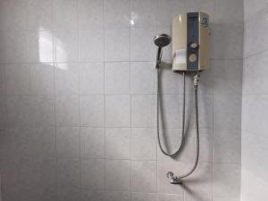 a shower in a bathroom with a shower head at Samiya Guesthouse in Ban Bang Saen (1)