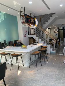 a kitchen with a counter with chairs and a staircase at Crescent Bay SUP in Shuili