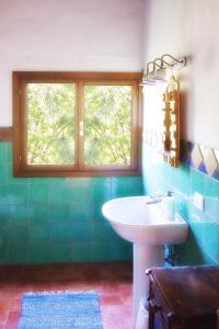 a bathroom with a sink and a window at La Lepre Bianca in Cento