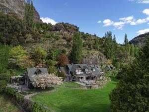 an aerial view of a house in the mountains at Trelawn Riverside Cottages in Queenstown