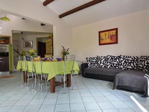 a living room with a table and a couch at Stylish holiday home near St Br s in Saint-Brès