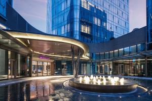 a large building with a fountain in front of it at Crowne Plaza Shanghai Hongqiao by IHG in Shanghai