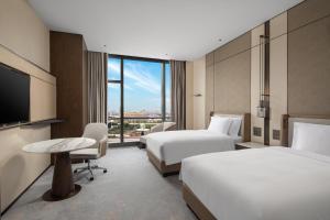 a hotel room with two beds and a tv at Crowne Plaza Shanghai Hongqiao by IHG in Shanghai +37 photos