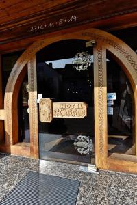 a glass door with a sign in the middle at Hotel Landgasthaus Rössle in Hofweier