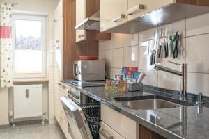 a kitchen with a sink and a microwave at Lieblingsplatz in Ofterschwang