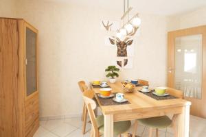 a dining room with a wooden table and chairs at Lieblingsplatz in Ofterschwang +1 photo