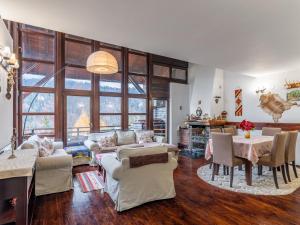 a living room filled with furniture and a table at Andu's Chalet Azuga in Azuga