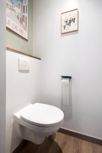 a bathroom with a toilet and a picture on the wall at - Le petit Rochelais -Calme&Cosy- Wifi-Netflix in La Rochelle