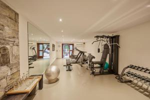 a gym with treadmills and exercise bikes in a room at Palacio Can Marqués in Palma de Mallorca