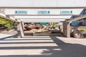 a pavilion with directional signs on a building at LaLiBay Resort & Spa - Adults Only in Perdika